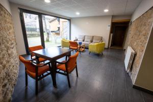 a waiting room with a table and chairs and a couch at Hotel Casa Domenc in Aren