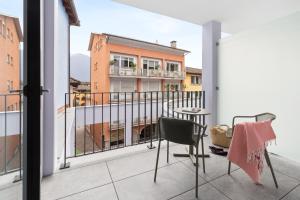 a balcony with a table and chairs on a building at Living Ascona Boutique Hotel - Smart Hotel in Ascona