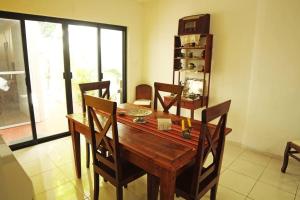 a dining room with a wooden table and chairs at House at Centro Histórico with pool in Mérida