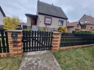 a black fence in front of a house at Ferienhaus Pusteblume in Lübben