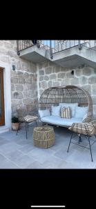 a rattan bed and two chairs on a patio at Villa Marija in Gromača