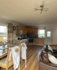 a kitchen and living room with a table and a couch at Bundoran seclusion in Bundoran