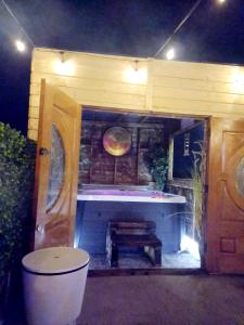 an outdoor bath room with a tub and a bench at Bundoran seclusion in Bundoran