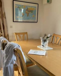 a dining room table with a wooden table with chairs and a table at Bundoran seclusion in Bundoran