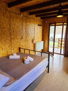a bedroom with a bed with towels on it at Kazbegi 5054 in Stepantsminda