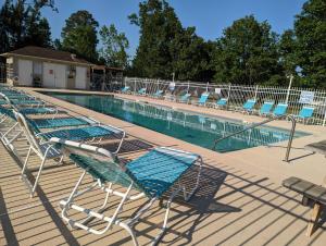 a row of chairs sitting next to a swimming pool at Great Central Location - Between Everything in Myrtle Beach