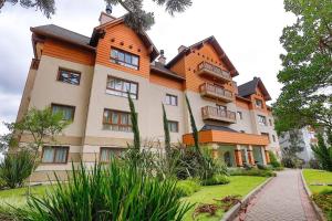 a large house with an orange and white at Residencial via Florida AP102 D in Gramado