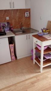 a kitchen with a sink and a counter top at Apartman Lavanda in Trebinje