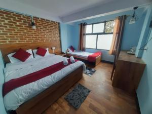 a bedroom with a bed and a brick wall at Bubble Beds in Darjeeling