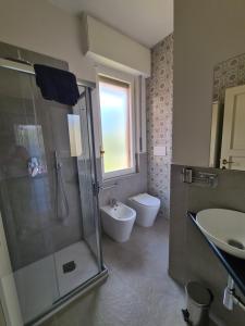 a bathroom with a shower and a toilet and a sink at Grande Attico con Vista Vicino al Centro by PortofinoVacanze in Rapallo +60 photos