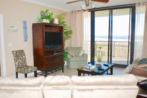 a living room with a couch and a tv in it at Holiday Isle 412 in Dauphin Island