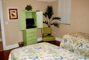 a bedroom with a green cabinet and a bed at Holiday Isle 412 in Dauphin Island