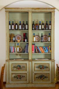 a wooden hutch with bottles of alcohol in it at Agriturismo Tarantola in Alcamo
