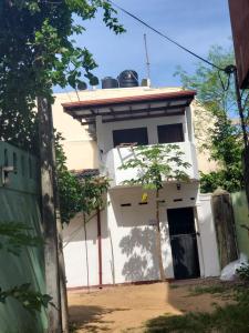 a white building with a roof at Mount lavinia home in Watumulla