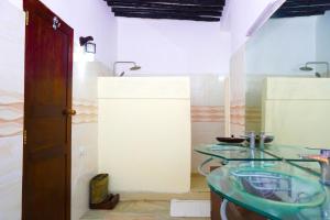 a bathroom with two glass sinks in a room at Al Johari Hotel & Spa in Zanzibar City