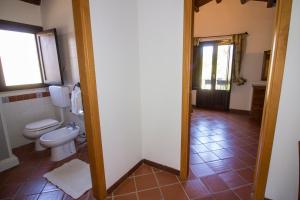 a bathroom with a toilet and a window at Agriturismo Tarantola in Alcamo +87 photos