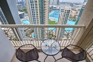 a balcony with a table and two chairs on a balcony at Bella Vista - 29 Boulevard Downtown Burj Khalifa in Dubai