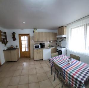 a kitchen with a table with a table cloth on it at Casa Mi&Ra in Lepşa