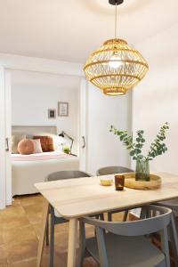 a dining room with a table and a bed at Columbus Apartment in Barcelona