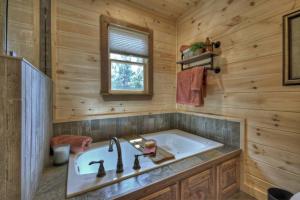 a bathroom with a tub and a sink at Sunset Ridge w Stunning 5 Star Views & Hot Tub in Blue Ridge