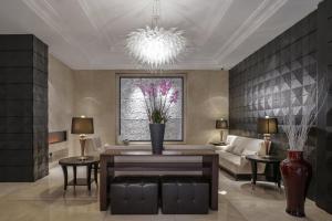 a living room with a couch and a chandelier at Lugal, A Luxury Collection Hotel in Ankara