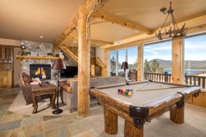 a living room with a pool table and a fireplace at Big Bear Village View Haus is a large pet and kid friendly chalet with hot tub located a short walk to village in Big Bear Lake
