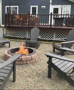 two benches and a fire pit on a patio at Chair Lift Lodge- Best Location in EVL Village! in Ellicottville