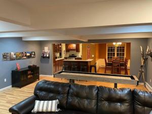 a living room with a couch and a kitchen at Chair Lift Lodge- Best Location in EVL Village! in Ellicottville