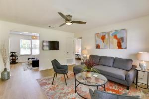 a living room with a couch and a table at Bright Tallahassee Vacation Rental Near FSU and FAMU in Tallahassee