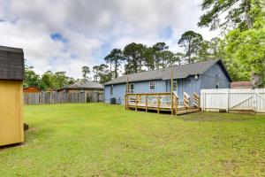a large yard with a blue building and a fence at Bright Tallahassee Vacation Rental Near FSU and FAMU in Tallahassee
