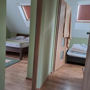 a room with two beds and an open door at Domki Oaza Spokoju Berezka in Berezka