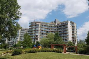 a large apartment building in front of a park at Danube Dream Superb view & garage in Budapest