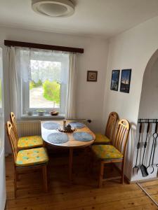 a dining room with a table and chairs and a window at Chata Hůrka in Horní Planá