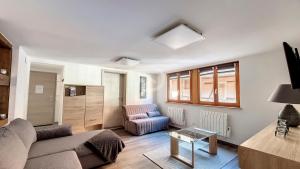a living room with a couch and a chair at Le Zen d'Eguisheim in Eguisheim +1 photo