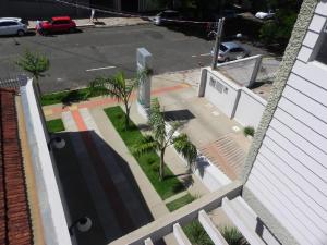 an aerial view of a street with a building and palm trees at Cerrado Hotel LTDA in Campo Grande