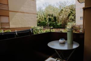 a small table with a green thermos on a balcony at Casa GINA a 2 passi dal mare in Terracina