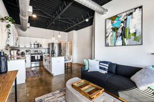 a living room with a couch and a kitchen at Brand New Condo near downtown Nash w washer dryer in Nashville +9 photos
