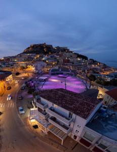 a building with a large pool on top of it at B&B PIAZZA NUOVA in Castelsardo