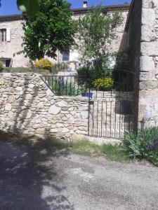 Plan-de-Baix的住宿－Les Fonts de Baix，建筑前有门的石墙