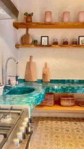 a kitchen with a sink and a counter top with a sink at Dar Vevé - Design, style & relax in Dar el Bacha in Marrakesh