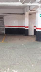 an empty parking garage with a red and white wall at Apartamento Tiboli con parking gratuito in Bilbao