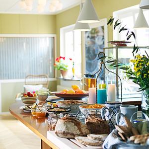 a kitchen with a table with food on it at Gårdens B&B in Simrishamn