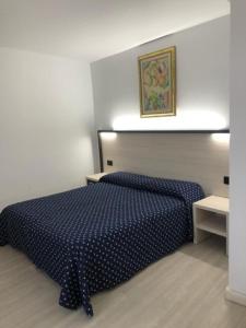 a bedroom with a blue comforter on a bed at Alloggi Pontecorvo Liviana in Padova