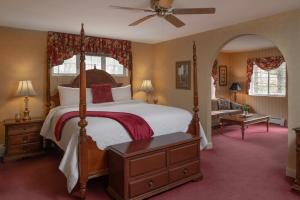 a bedroom with a canopy bed and a living room at Christmas Farm Inn and Spa in Jackson