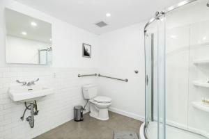 a bathroom with a toilet and a sink and a shower at Luxurious 4 BR townhouse in New York