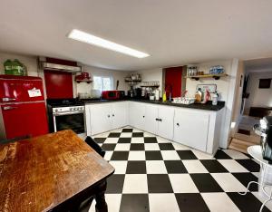 a kitchen with a black and white checkered floor at Peaceful Lily Pad Cottage In Hubbards in Hubbards