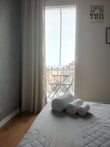 Posteľ alebo postele v izbe v ubytovaní white caves catania rooms