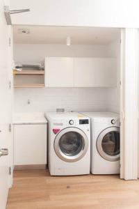 uma lavandaria com máquina de lavar e secar roupa em Apartamento una habitación DLX em Echeverría