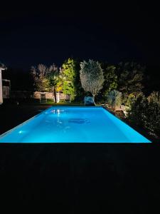 a blue swimming pool at night at Villa Porto-vecchio 4 chambres avec piscine in Porto-Vecchio