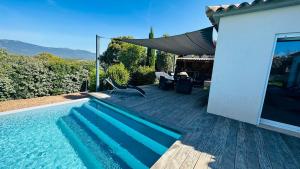 a swimming pool in front of a house at Villa Porto-vecchio 4 chambres avec piscine in Porto-Vecchio